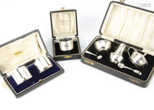 A 1950s cased silver three piece cruet set, together with a pair of cased napkin rings and a