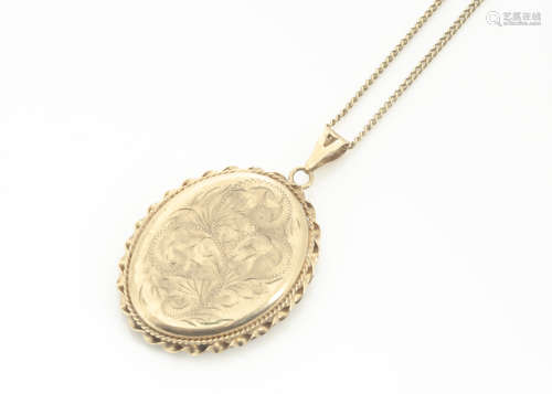 A modern oval engraved 9ct gold hinged locket, with floral decoration, with twist design edge, on