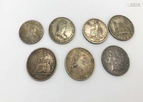 Seven 19th Century and later coins, including a US 1896 dollar, a Spanish trade coin, a 1959
