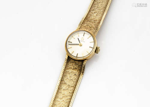 A c1970s Omega 9ct gold lady~s wristwatch, circular case with integrated 9ct gold mesh strap, 19.3g,