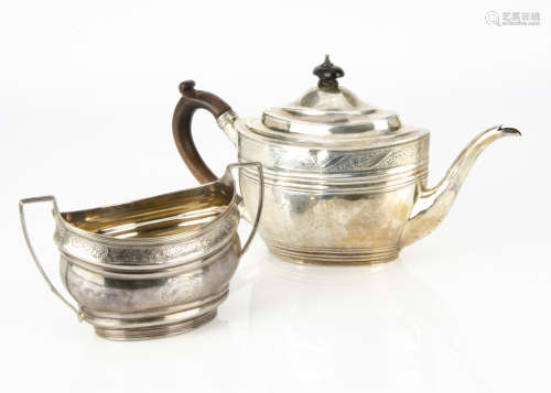 A Georgian style white metal teapot and similar sugar basin, the oval teapot with wooden handle