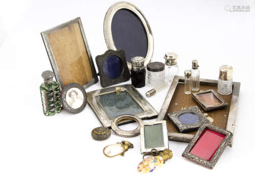 A collection of Victorian and later cut glass scent bottles and photograph frames, including a