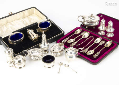 A group of silver cruet items, including a three piece Art Deco set, a pair of mustards, a pair of