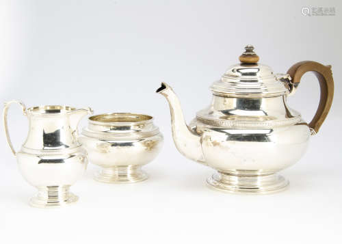 A George V silver three piece tea set from S Ltd, Birmingham 1930, comprising teapot, sugar basin