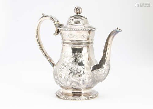 A 19th Century white metal coffee pot, bulbous body with raised floral designs, applied handle