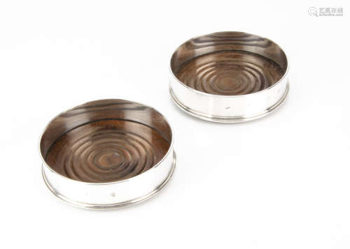 A pair of modern silver wine bottle coasters from DRM, London 1986