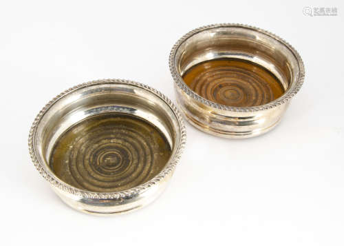 A pair of late Victorian silver plated wine bottle coasters