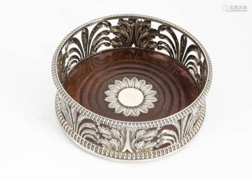 A 19th Century silver wine bottle coaster, the pierced sides with acanthus and other leaves, the