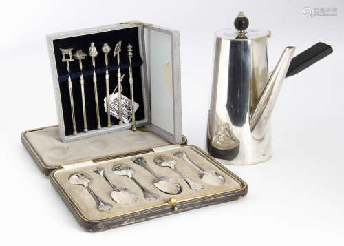 An Art Deco set of Japanese silver swizzle sticks, in box and each with differing terminal, together