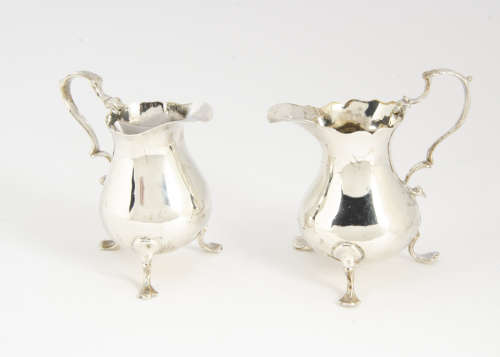 Two George III period silver milk jugs, both similar on three supports, one repaired, 4.5 ozt and