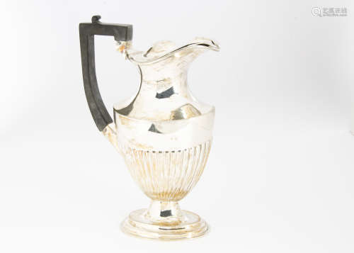 An Edwardian silver hot water jug by WB Ltd, oval base, fluted lower, applied black handle, lid