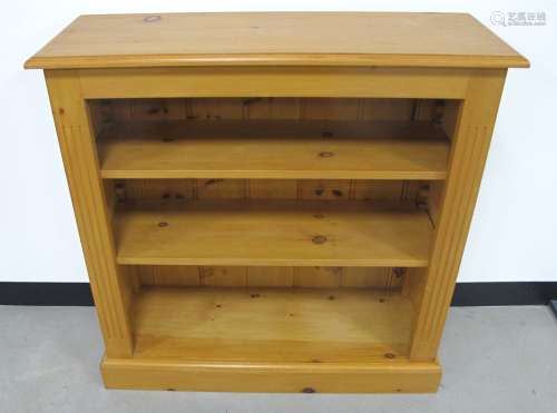 A contemporary pine open bookcase, with moulded top, two adjustable shelves and plinth base, 91cm