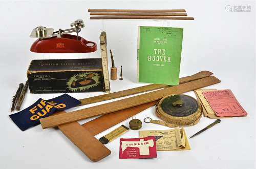 A collection of measuring instruments, including a lawn tennis measure, a brass tape measure, a 19th