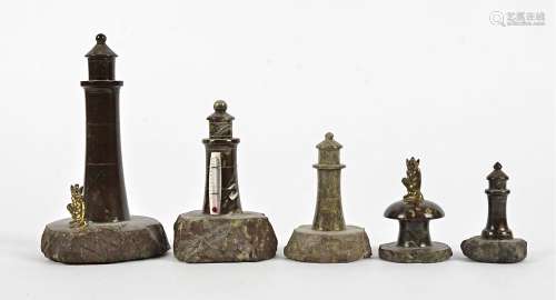 A small group of serpentine stone collectables, taking the form of lighthouses and a toadstool