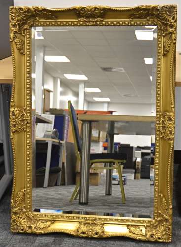 A contemporary swept gilt frame mirror, with bevelled plate, 109cm x 79cm