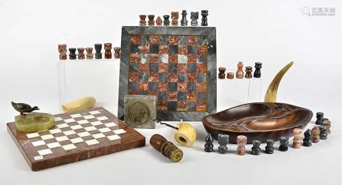 Two marble chess boards, together with a small quantity of chess pieces, but not a full set, a