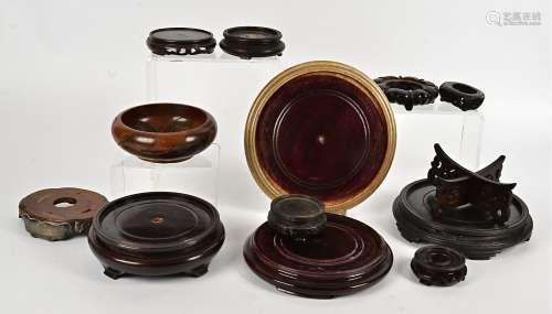 A large quantity of Asian wooden stands, circular in form, assorted shapes and sizes, dimeter of