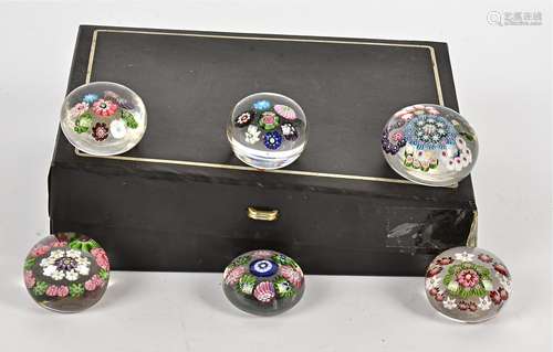 Six small Clichy paperweights, one with concentric millefiori cane decoration taking the form of a