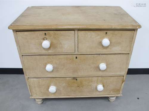 A 19th Century stripped pine chest of drawers, two short drawers over two long drawers, with white