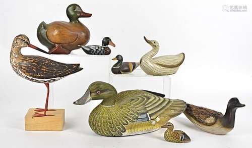 A collection of wooden models of wildfowl, some handpainted, together with a carved stone example (