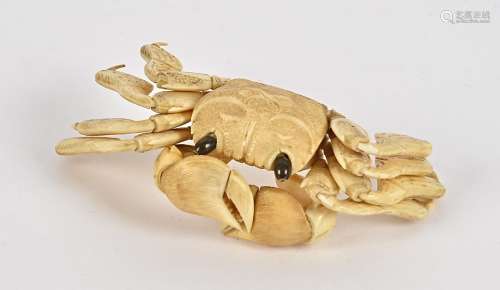 A Japanese Meiji period okimono ivory study of a crab, with connected limbs and claws, and