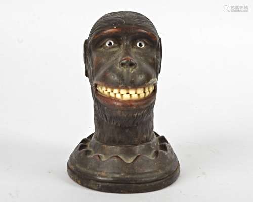 A Black Forest carved wooden monkey's head, with glass eyes, cut teeth and a hinged jaw, possibly