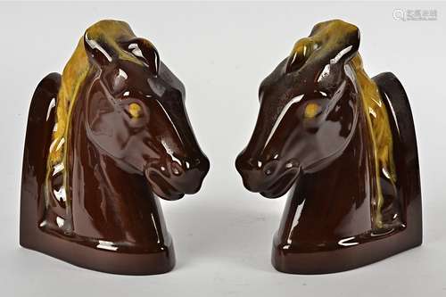 A pair of pottery bookends, modelled as horses heads (2)