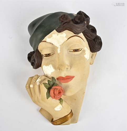 An Art Deco plaster wall pocket, in the form of a fahionable woman's head with a rose clutched to
