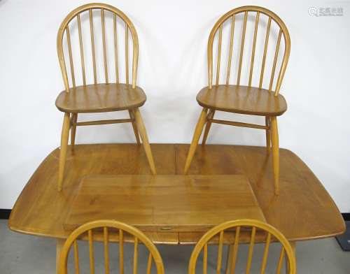 An Ercol blonde extending dining table, 77cm x 150cm, leaf 71cm, height 71cm, with a set of four
