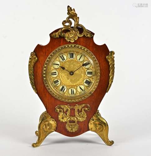 An early 20th Century French style clock, gilt dial decorated with a scene of a man looking across