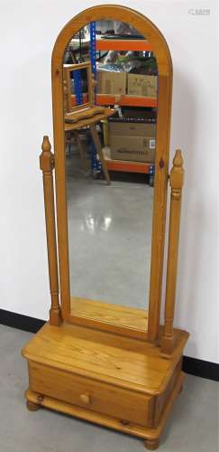 A contemporary pine cheval mirror, with arched top, supported by two turned columns, with drawer