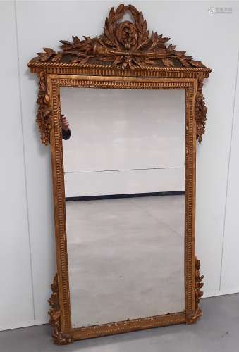 An 18th Century gilded mirror, ornate pediment with foliate, torch and quiver decoration, foliate