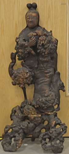 An early 19th Century Chinese root carving, modelled as an immortal standing clutching a root in