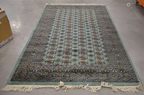 A Middle Eastern 20th Century woollen rug, with a sequential geometric pattern to the central panel,