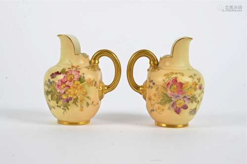 A pair of Royal Worcester blush ivory jugs, with handpainted floral decoration and gilt, height 10.