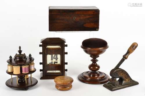 A collection of 19th & 20th Century treen, including a thread holder, desk calendar, pin cushion,