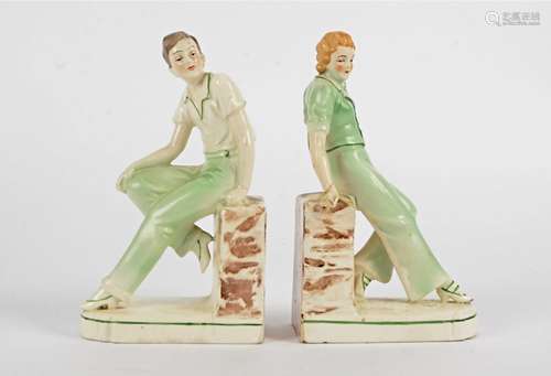 A pair of early 20th Century bookends, taking the form of youthful male and female companions,