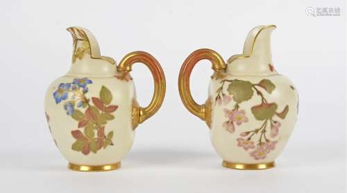 A pair of Royal Worcester flat-back jugs, each with with gold gilt and floral decoration on a