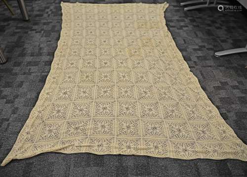 A 20th Century crochet style worked bed sheet, with multiple floral panels, 228cm x 146cm