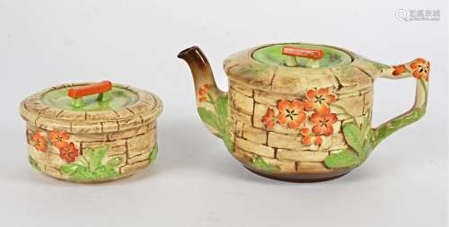 A Thomas Lawrence Falcon Ware teapot and sugar bowl, c.1930, in the 'Wishing Well' pattern with hand