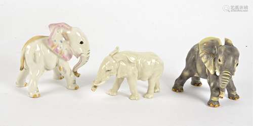 Three porcelain elephants, one a grey Nymphenburg study, height 11.5cm, together with another