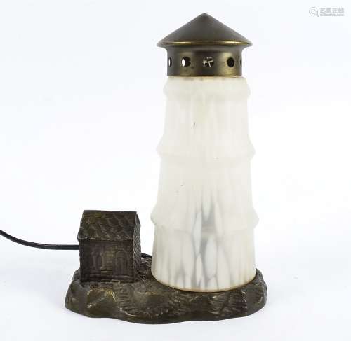 A continental novelty table light, the cast iron base with frosted glass shade surmounted by gilt