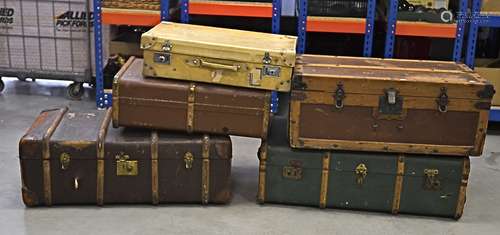 Two large early 20th Century wooden travelling trunks, one with iron binding and side handles,