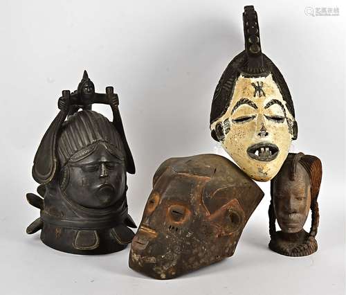 A collection of African masks, to include a Igbo maiden spirit mask, a Kuba mask, Makonde mask,