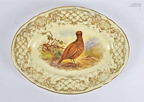 A 19th Century Royal Worcester oval plate, painted with a study of a pheasant with a gilt