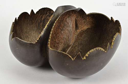 An antique coco-de-mer (lodoicea maldivica) seed pod, carved to form a two-division basket with