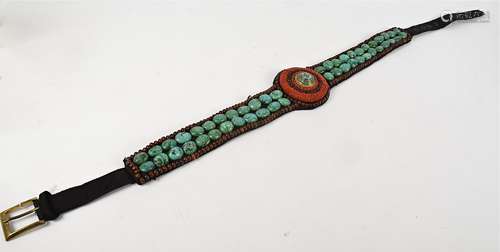 A Tibetan belt, embellished with red glass beads and large turqoise style stones, length 106cm