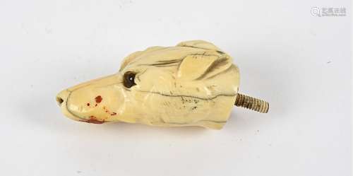 A 19th Century European ivory carving, taking the form of a dog's head, with beaded glass eyes,