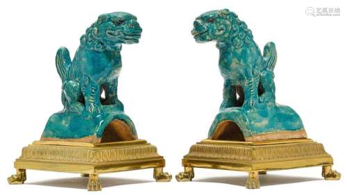 PAIR OF FOO DOGS ON A BRONZE MOUNT. The turquoise …