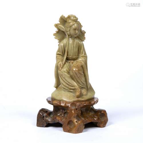 Soapstone figure of Guanyin Chinese seated with hands resting on her lap, on a rocky shaped base